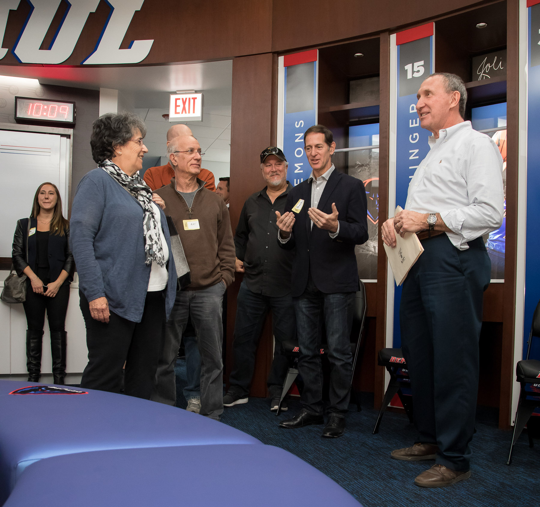 Bob Janis, vice president of facility operations, far right, answers questions about the women's basketball locker room. (DePaul University/Jeff Carrion)